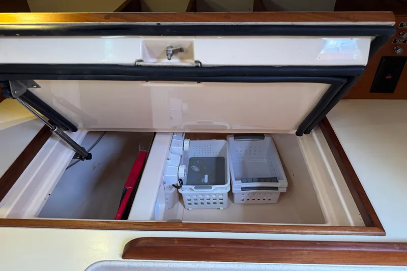 True North Yacht Photos Pics Storage compartment on 2004 Island Packet 420 yacht with organized baskets.