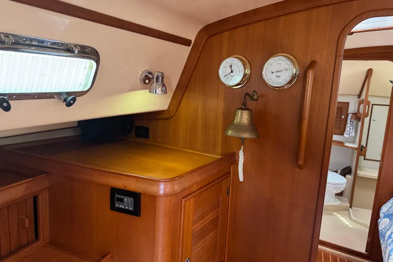 True North Yacht Photos Pics Interior of 2004 Island Packet 420 yacht with wooden cabinetry and nautical instruments.