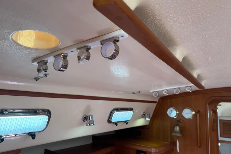 True North Yacht Photos Pics Interior of 2004 Island Packet 420 yacht with wooden accents and porthole windows.