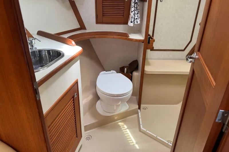 True North Yacht Photos Pics 2004 Island Packet 420 yacht bathroom with sink, toilet, and shower area.