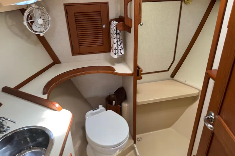 True North Yacht Photos Pics 2004 Island Packet 420 yacht bathroom with sink, toilet, and shower area.