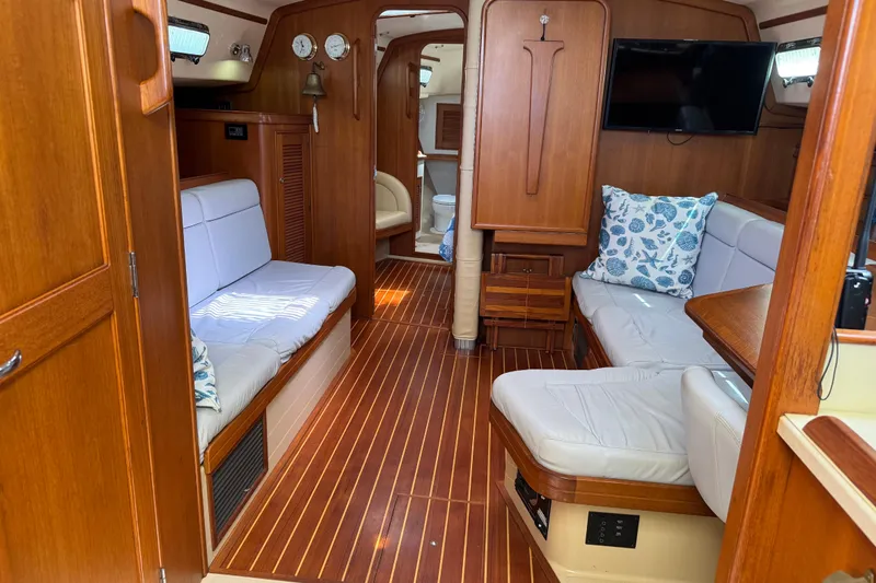 True North Yacht Photos Pics Interior of 2004 Island Packet 420 yacht with wooden finish and cozy seating area.