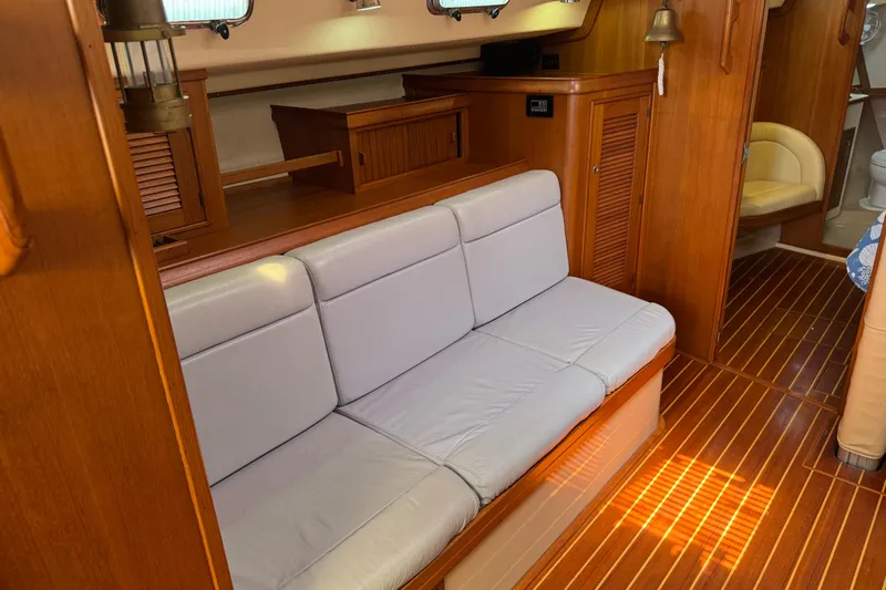 True North Yacht Photos Pics Interior of 2004 Island Packet 420 yacht with wooden flooring and cushioned seating.