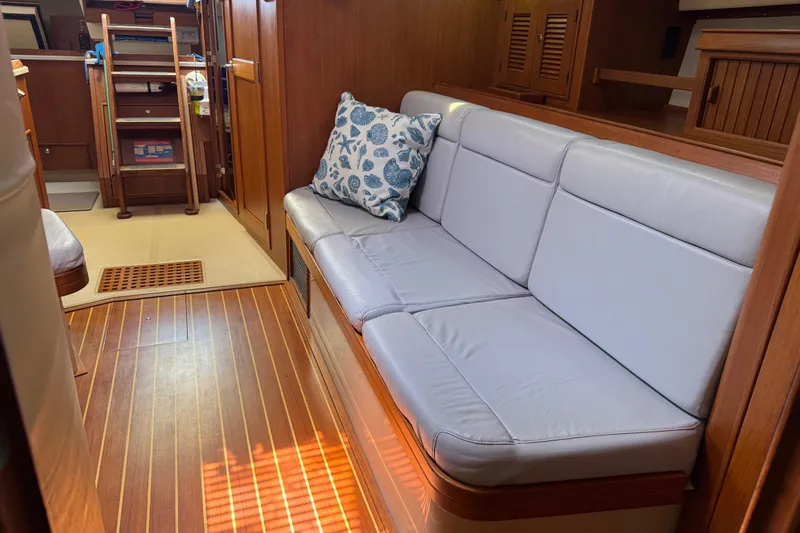 True North Yacht Photos Pics Interior of 2004 Island Packet 420 yacht with cushioned seating and nautical decor.
