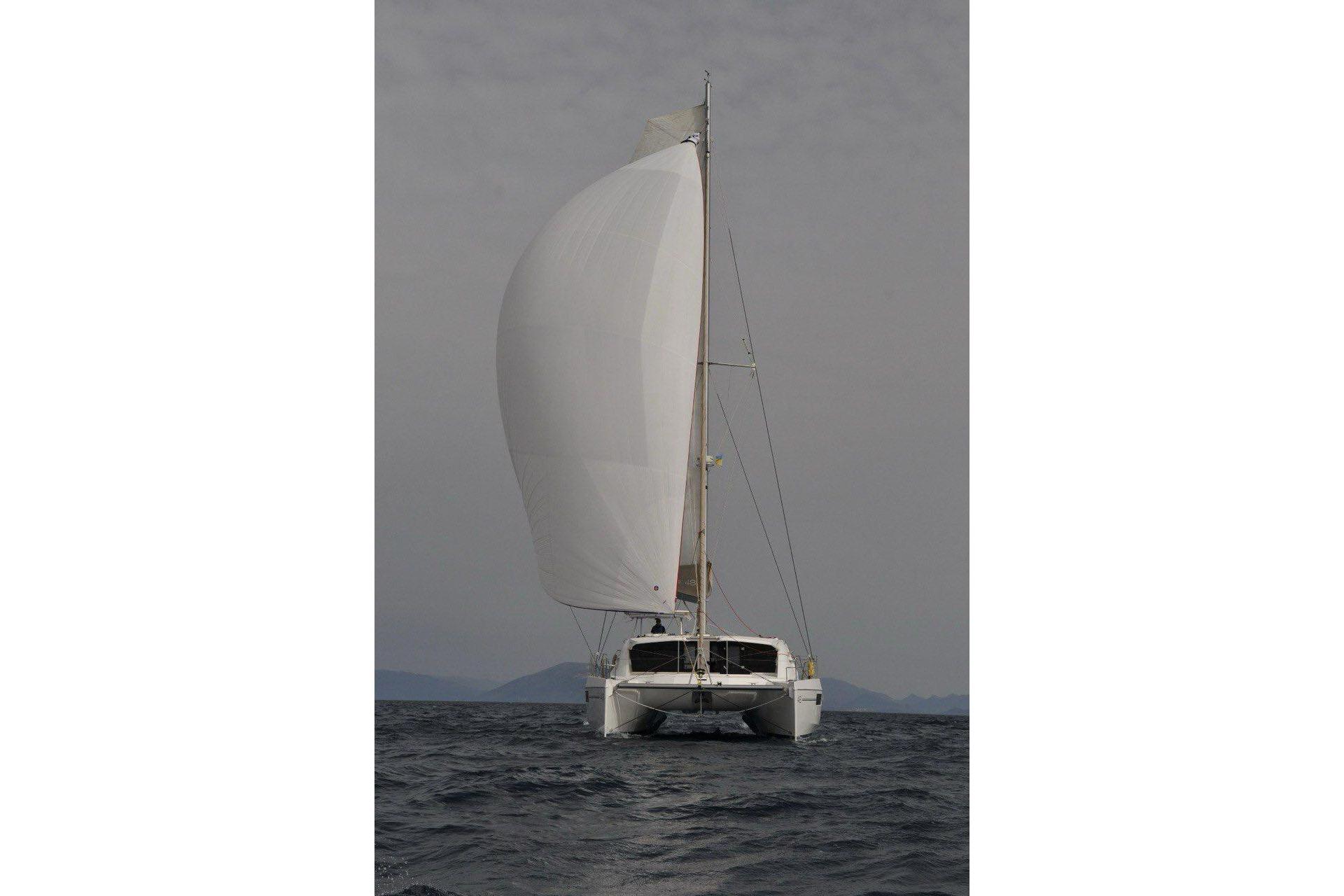 2015 Leopard 48 catamaran sailing on open water with full sails.