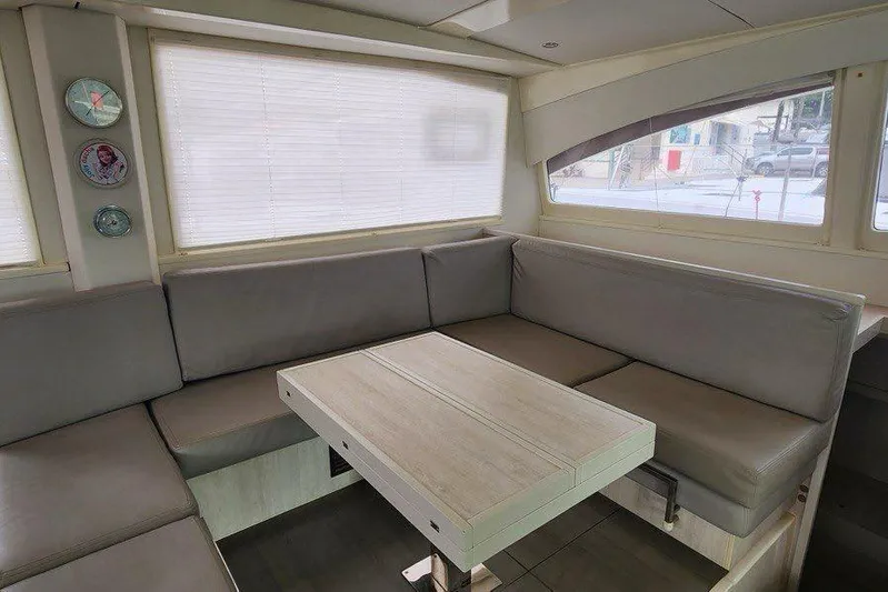 Jolly Dacha Yacht Photos Pics Luxurious interior of 2015 Leopard 48 yacht with modern seating and table.