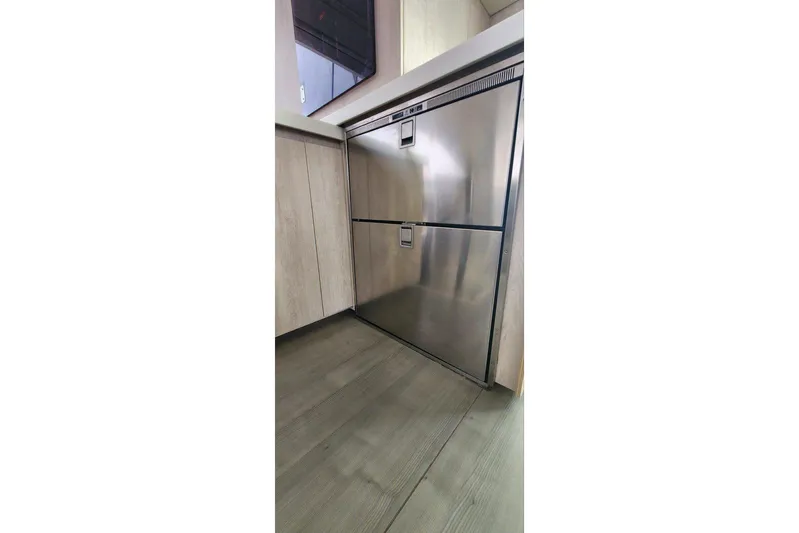 Jolly Dacha Yacht Photos Pics Stainless steel refrigerator in a modern kitchen on a 2015 Leopard 48 yacht.