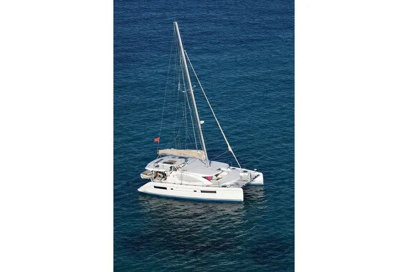 Jolly Dacha Yacht Photos Pics 2015 Leopard 48 catamaran sailing on clear blue ocean waters.