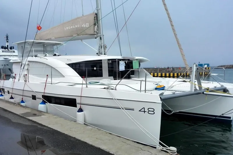 Jolly Dacha Yacht Photos Pics Leopard 48 catamaran docked at a marina, 2015 model, overcast sky.
