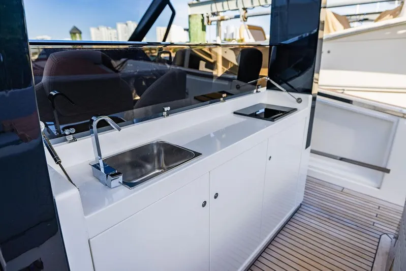  Yacht Photos Pics Astondoa 377 yacht 2023, sleek outdoor kitchenette with sink and modern design.