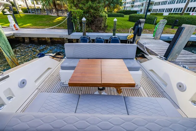  Yacht Photos Pics Astondoa 377 yacht 2023 model with elegant seating and wooden table on deck.