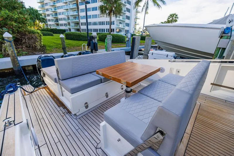  Yacht Photos Pics Luxurious 2023 Astondoa 377 yacht deck with elegant seating and wooden table.