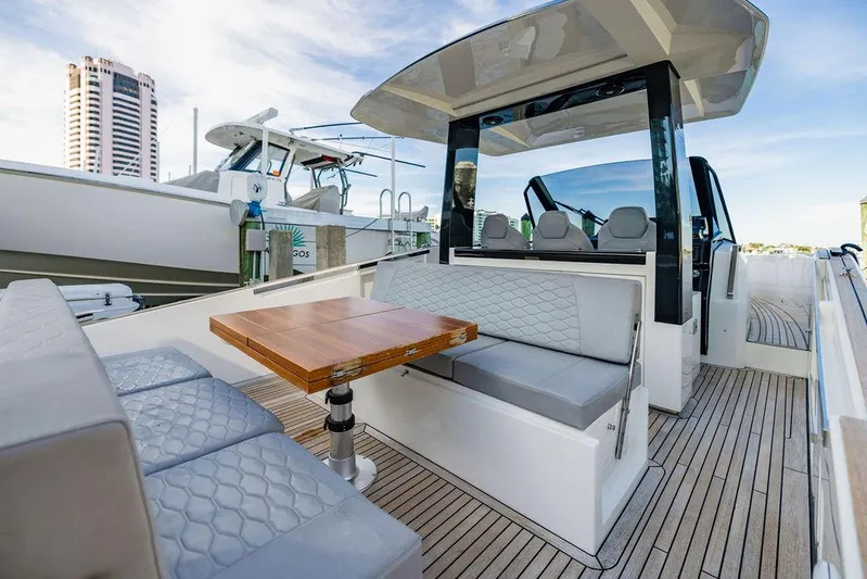  Yacht Photos Pics 2023 Astondoa 377 yacht interior with modern seating and wooden table.