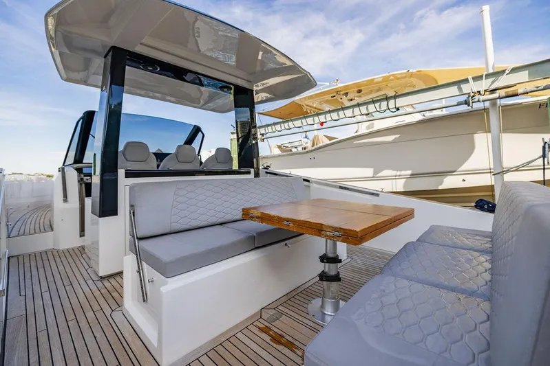  Yacht Photos Pics 2023 Astondoa 377 yacht interior with modern seating and wooden table.