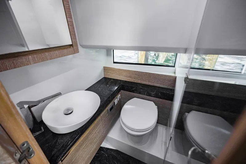  Yacht Photos Pics Luxurious bathroom in 2023 Astondoa 377 yacht with modern fixtures and elegant design.