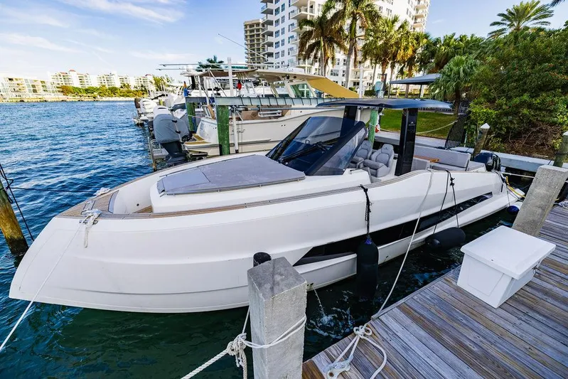 Yacht Photos Pics 2023 Astondoa 377 yacht docked at a marina, surrounded by water and palm trees.