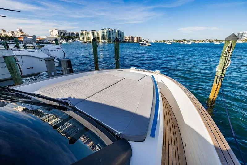  Yacht Photos Pics 2023 Astondoa 377 yacht docked in a scenic marina with clear blue waters.