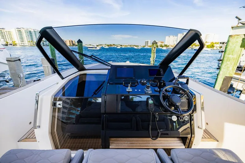  Yacht Photos Pics 2023 Astondoa 377 yacht helm with modern controls and waterfront view.