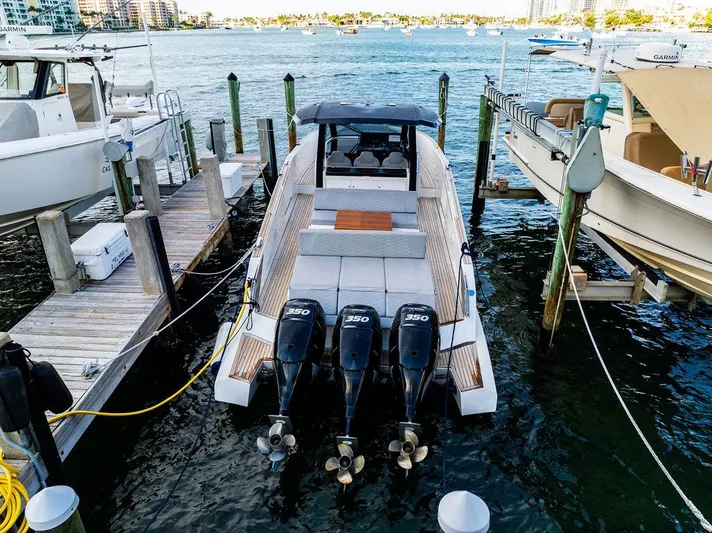  Yacht Photos Pics 2023 Astondoa 377 boat docked with triple outboard engines, waterfront view.
