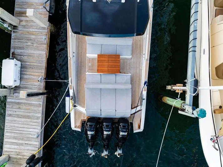  Yacht Photos Pics Aerial view of 2023 Astondoa 377 yacht docked, showcasing triple outboard engines.
