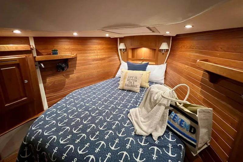  Yacht Photos Pics Cozy cabin interior of 2017 Tartan 4300 sailboat with nautical-themed bedding.