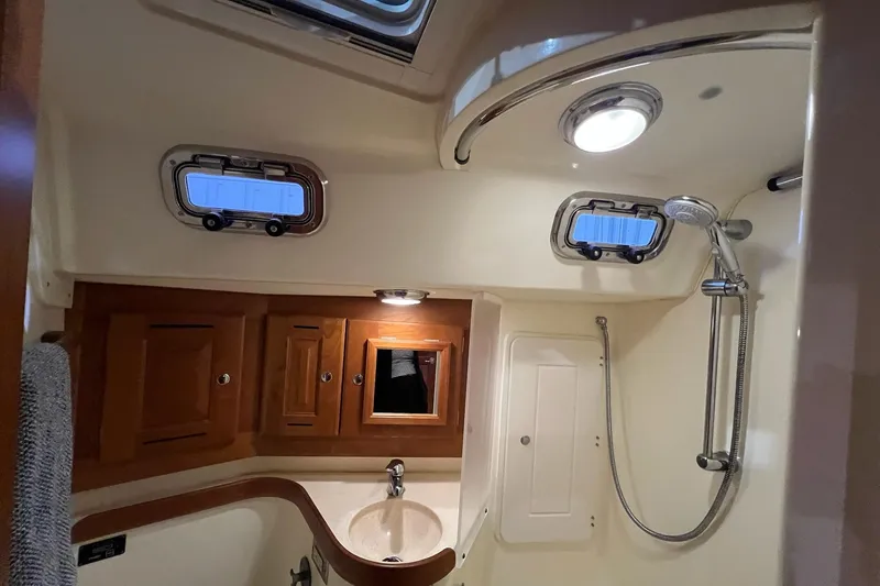  Yacht Photos Pics Luxurious 2017 Tartan 4300 yacht bathroom with shower, sink, and wooden cabinets.