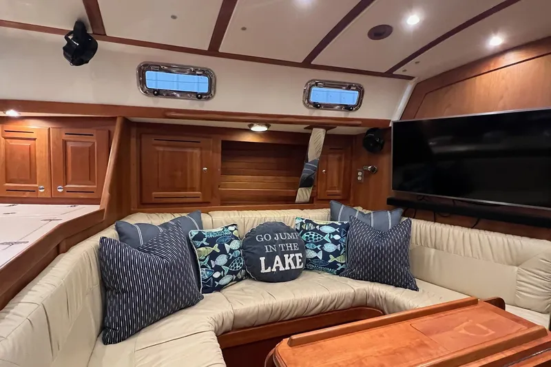  Yacht Photos Pics Luxurious 2017 Tartan 4300 yacht interior with cozy seating, decorative pillows, and wooden cabinetry.
