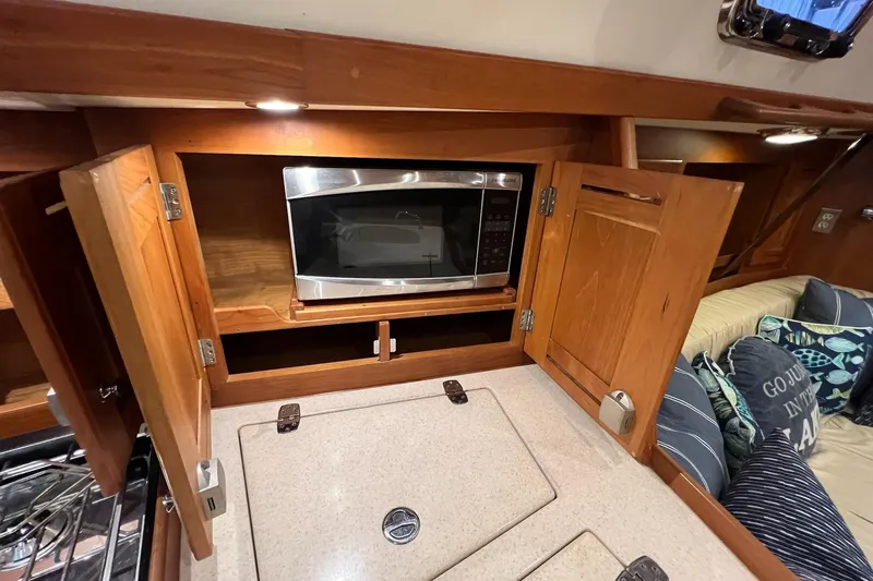  Yacht Photos Pics 2017 Tartan 4300 yacht interior with microwave and wooden cabinetry.