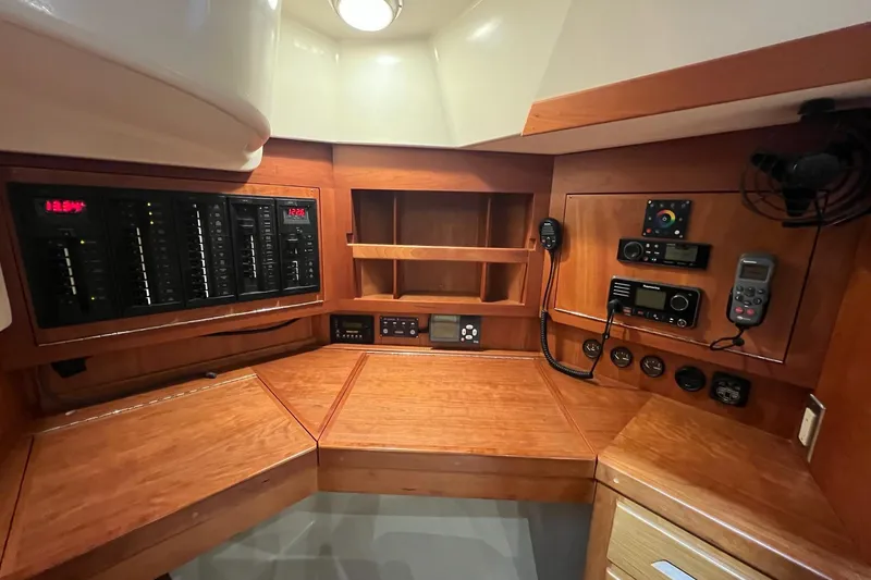  Yacht Photos Pics Control panel of a 2017 Tartan 4300 yacht with wooden cabinetry and electronic equipment.