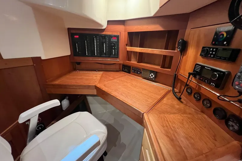  Yacht Photos Pics Navigation station of 2017 Tartan 4300 yacht with control panels and wooden finish.