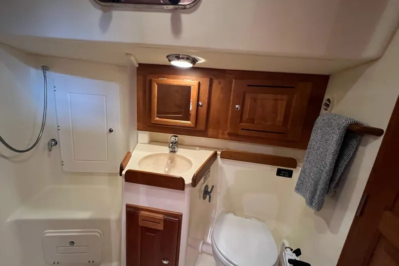  Yacht Photos Pics Bathroom interior of 2017 Tartan 4300 yacht with wooden cabinets and compact design.