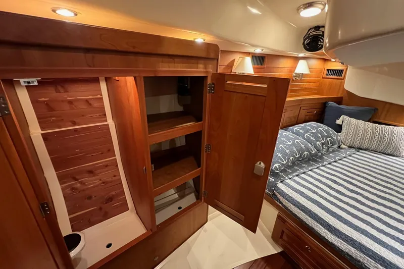  Yacht Photos Pics Luxurious 2017 Tartan 4300 yacht cabin with wooden cabinetry and cozy bedding.