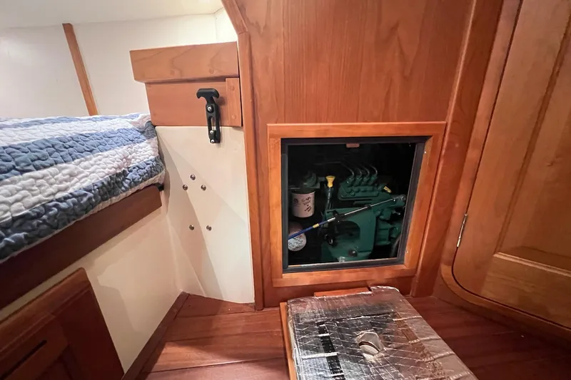  Yacht Photos Pics Interior of a 2017 Tartan 4300 sailboat showing engine access panel and wooden cabinetry.