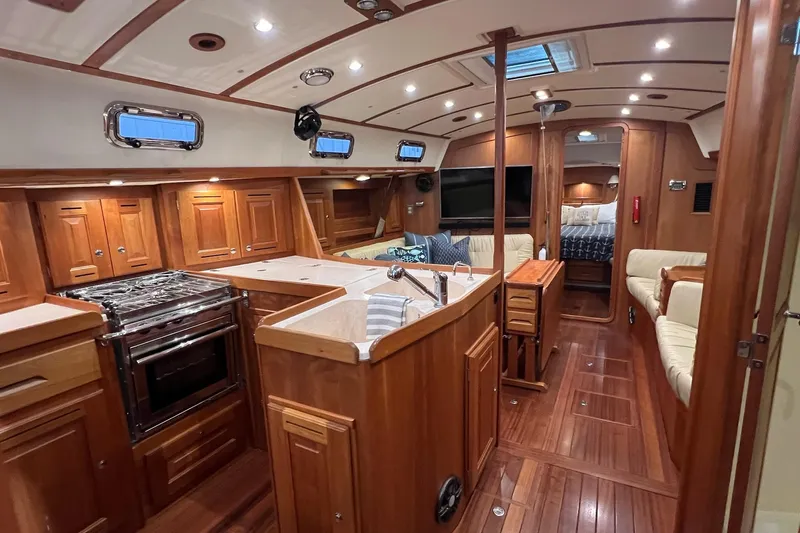  Yacht Photos Pics Luxurious 2017 Tartan 4300 yacht interior with wood finish, kitchen, and seating area.