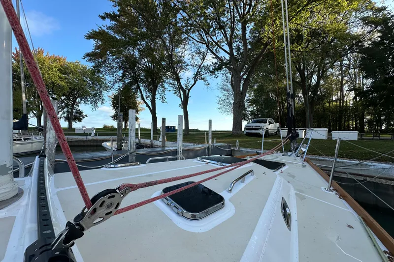  Yacht Photos Pics Sailboat Tartan 4300 (2017) docked near trees and parked vehicle.