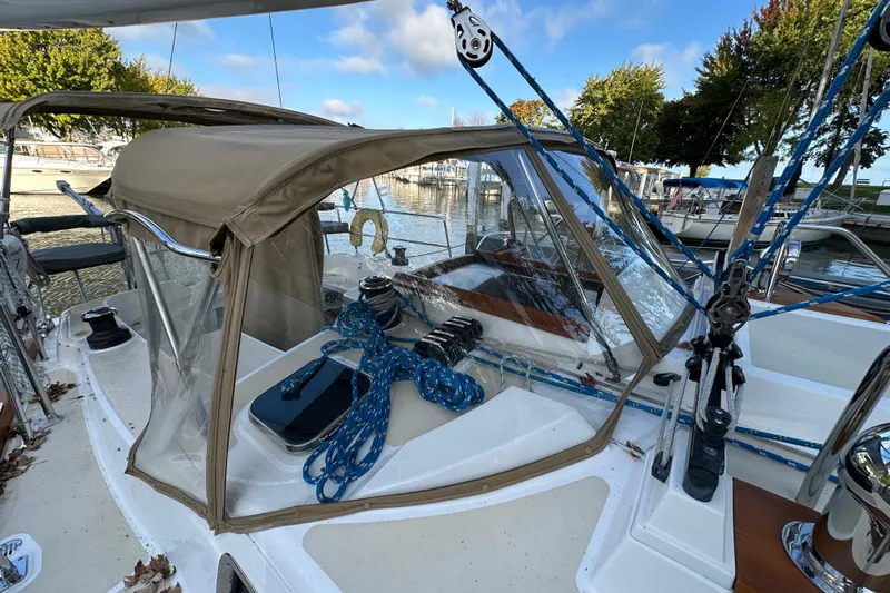 Yacht Photos Pics Sailboat cockpit of 2017 Tartan 4300 with ropes and canopy in marina setting.