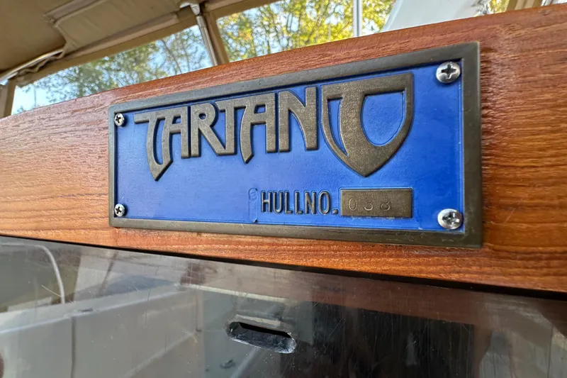  Yacht Photos Pics Tartan 4300 sailboat nameplate, hull number 038, on wooden surface, 2017 model.