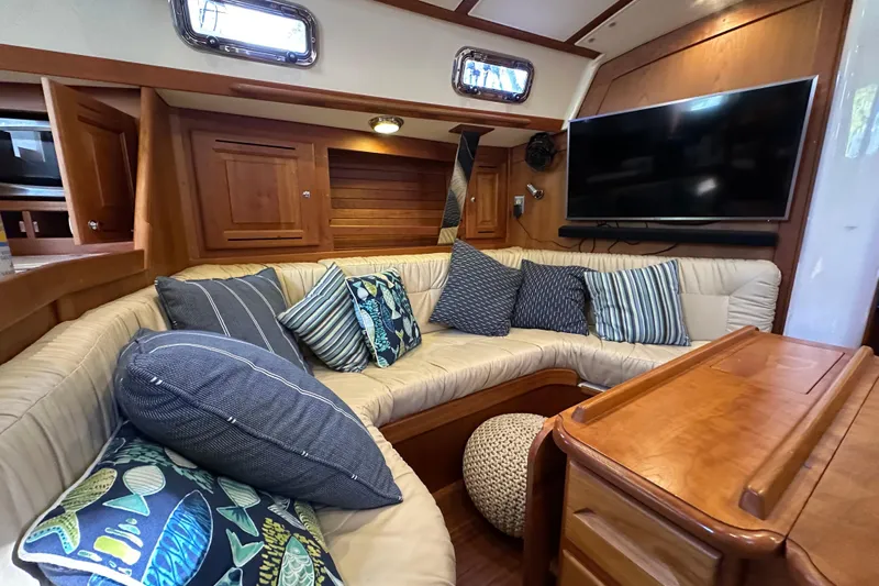  Yacht Photos Pics Cozy interior of 2017 Tartan 4300 yacht with plush seating and decorative pillows.