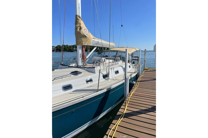  Yacht Photos Pics Sailboat Tartan 4300, 2017 model, docked at a wooden pier on a sunny day.