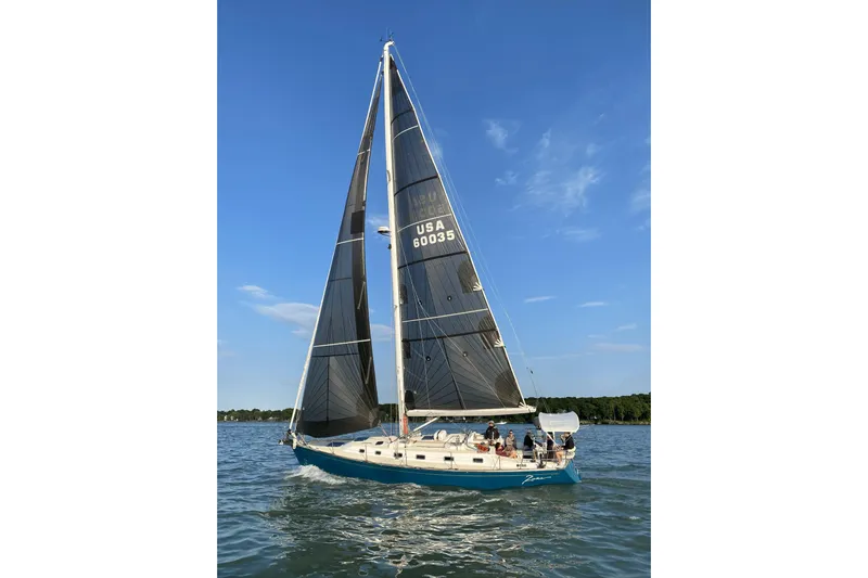  Yacht Photos Pics Sailing yacht Tartan 4300 (2017) on water under clear blue sky.