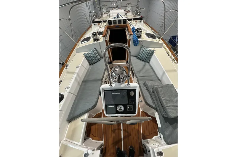  Yacht Photos Pics 2017 Tartan 4300 sailboat interior with cushioned seating and navigation equipment.