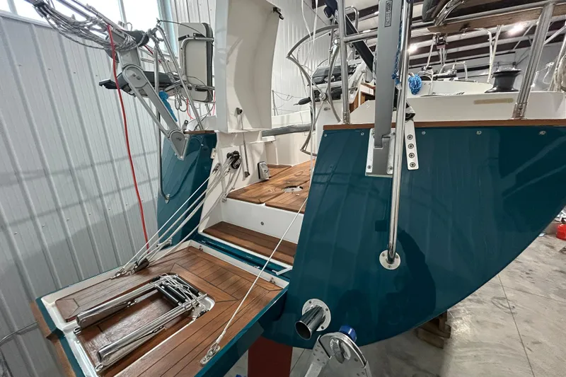  Yacht Photos Pics 2017 Tartan 4300 sailboat in a warehouse, showcasing its deck and rigging.