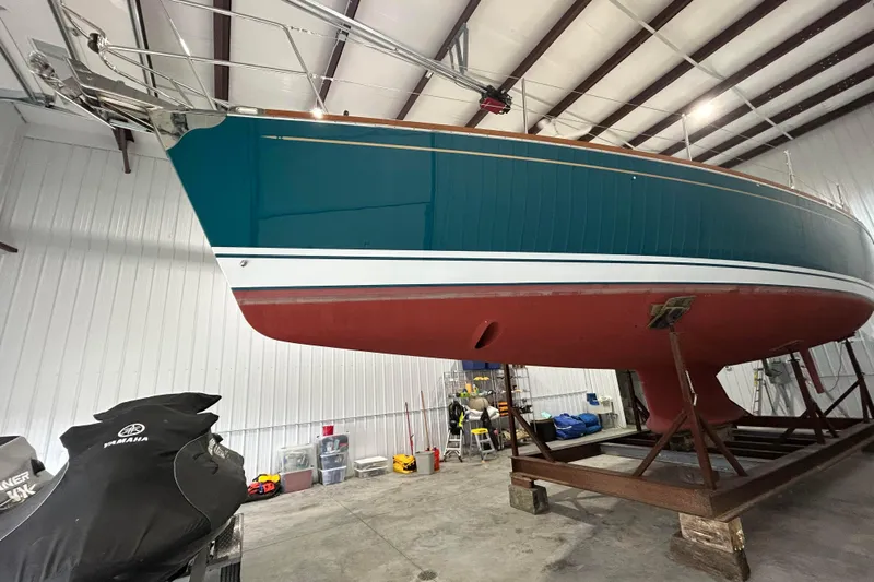  Yacht Photos Pics Tartan 4300 sailboat from 2017 in a storage facility, elevated on a stand.