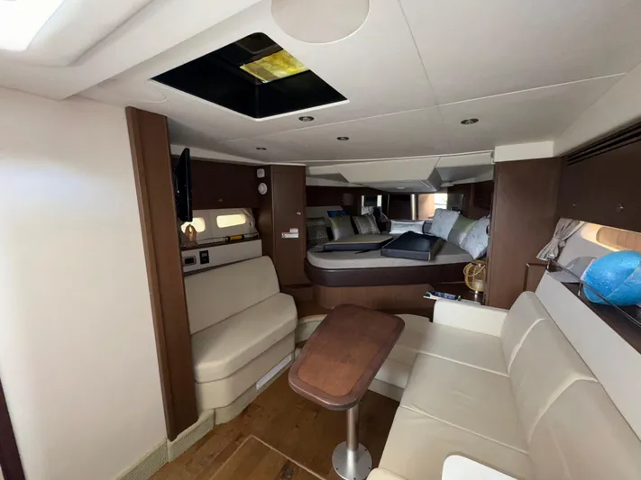 Idylwilde Yacht Photos Pics Interior of 2018 Sea Ray Sundancer 350 Coupe, featuring seating and sleeping areas.