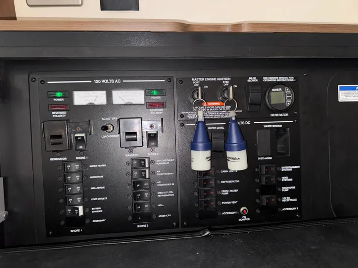 Idylwilde Yacht Photos Pics Control panel of a 2018 Sea Ray Sundancer 350 Coupe with switches and keys.