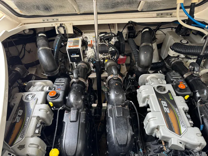 Idylwilde Yacht Photos Pics Engine compartment of a 2018 Sea Ray Sundancer 350 Coupe, showcasing dual engines and components.