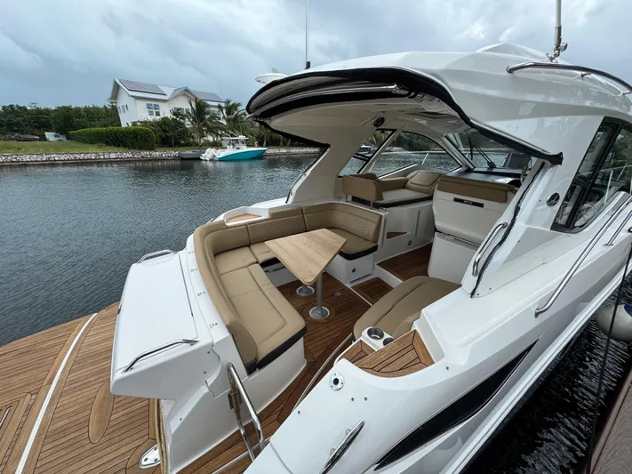 Idylwilde Yacht Photos Pics 2018 Sea Ray Sundancer 350 Coupe with elegant seating on a serene waterfront.