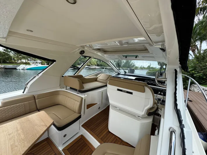 Idylwilde Yacht Photos Pics 2018 Sea Ray Sundancer 350 Coupe interior with tan seating and sleek design.