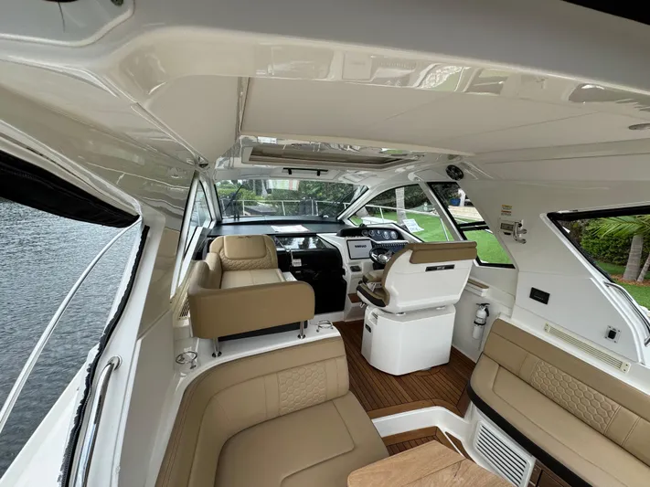 Idylwilde Yacht Photos Pics Interior of 2018 Sea Ray Sundancer 350 Coupe with beige seating and modern dashboard.