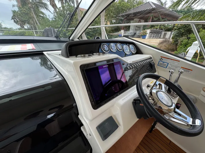 Idylwilde Yacht Photos Pics 2018 Sea Ray Sundancer 350 Coupe helm with modern controls and sleek design.